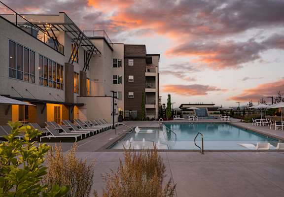 A modern building with a pool in front of it.