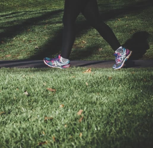 Person Walking in Park in Athletic Gear