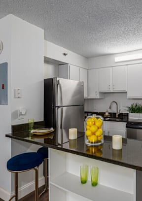 A kitchen with a refrigerator, stove, and oven.