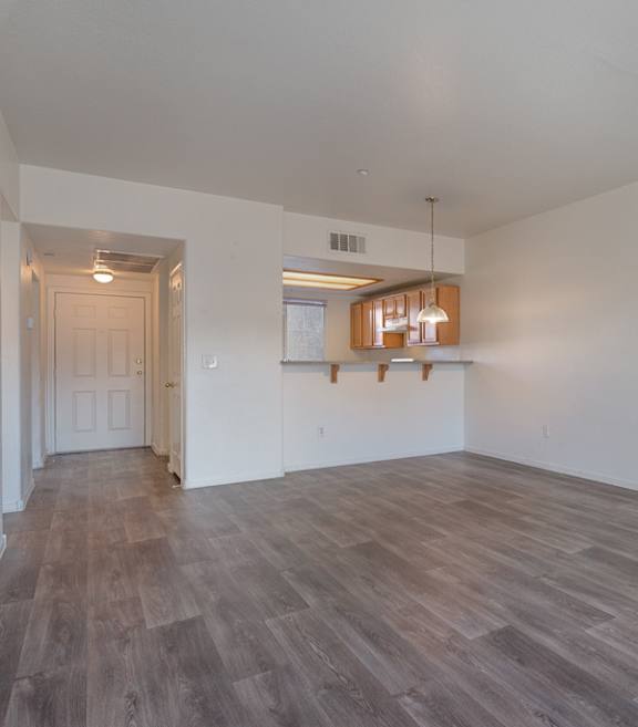 A room with wooden floors and white walls.