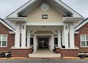 Thumbnail 4 of 5 - the front of a building with columns and a clock on it