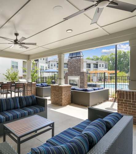 Outdoor area at our Indian Land apartments with seating next to the gated pool area.