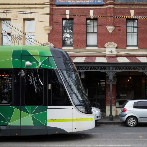 a bus parked on the street in front of a building