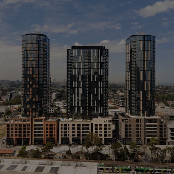 a rendering of a large brick building with a glass tower