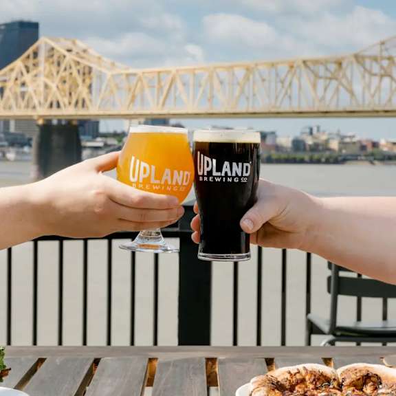 Two people toasting with glasses at AVIA North Shore Apartments, Jeffersonville, IN