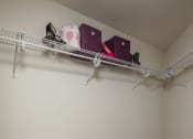 Thumbnail 26 of 27 - Walk in Closet with stool and items on shelf