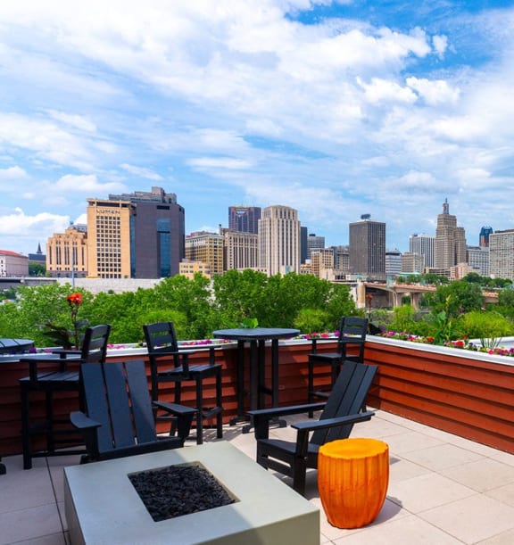 a rooftop patio with a city skyline in the background
