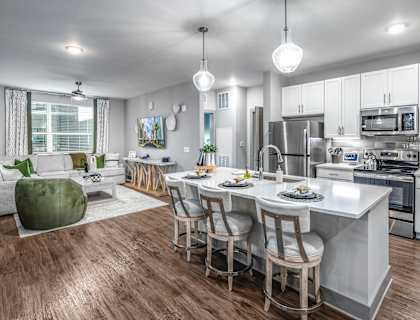 an open kitchen and living room with a large center island