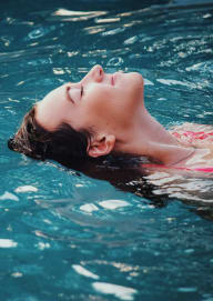 Woman Smiling while Floating in Water