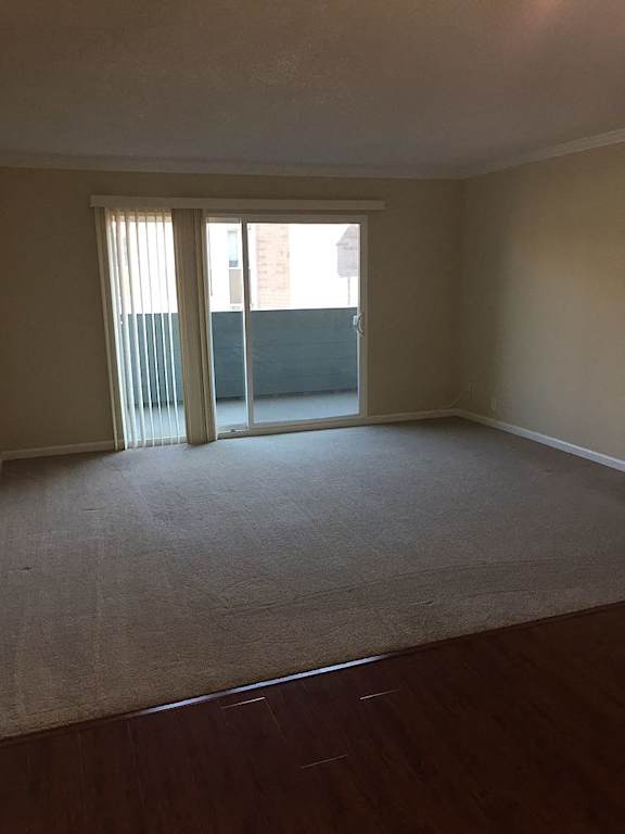 A room with a ceiling fan and a window with blinds.