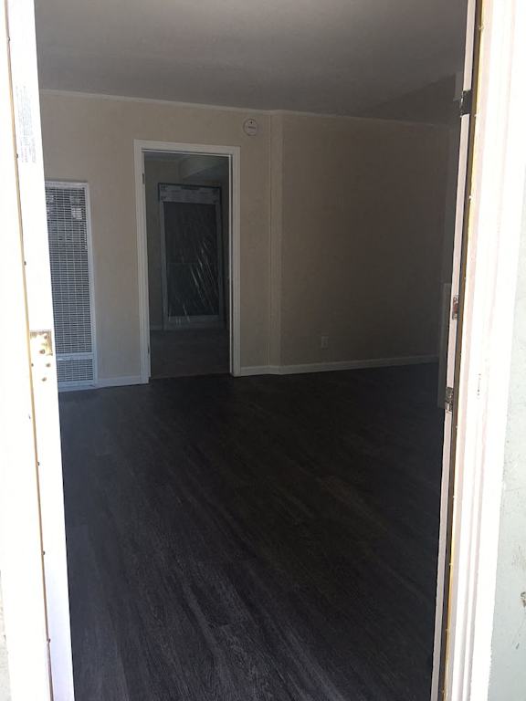 A room with a dark floor and white walls.