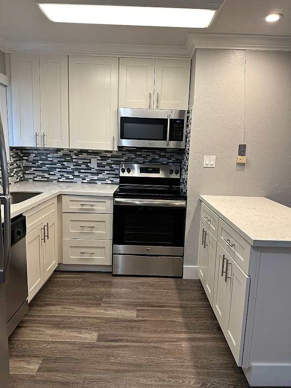 a kitchen with a sink and a stove and a refrigerator