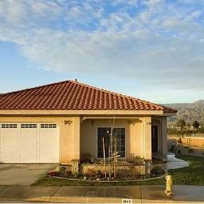 A house with a red tile roof and a garage door.