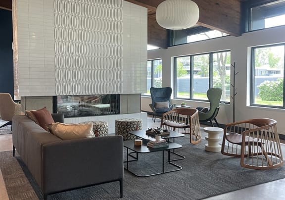 a living room with chairs and a table with plants at The Bosk Apartment Homes, Woodbury, 55125
