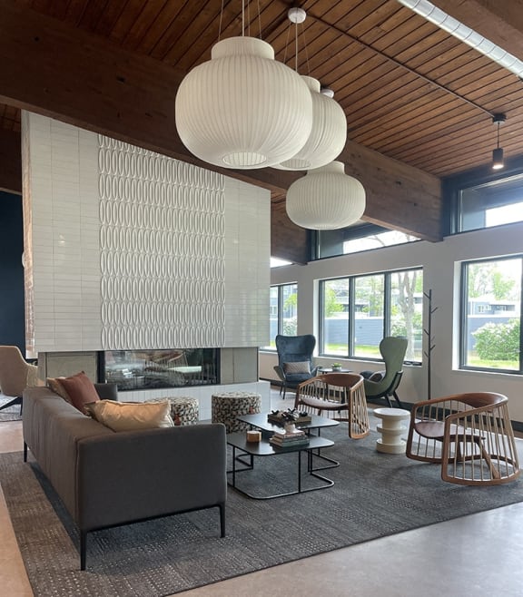 a living room with a couch and chairs and a fireplace