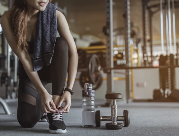 Woman working out in Fitness Centerat Boulders at Lookout Mountain Apartment Homes, Arizona, 85022