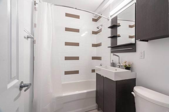 A white bathroom with a white tub and sink.at 161 St. George, California