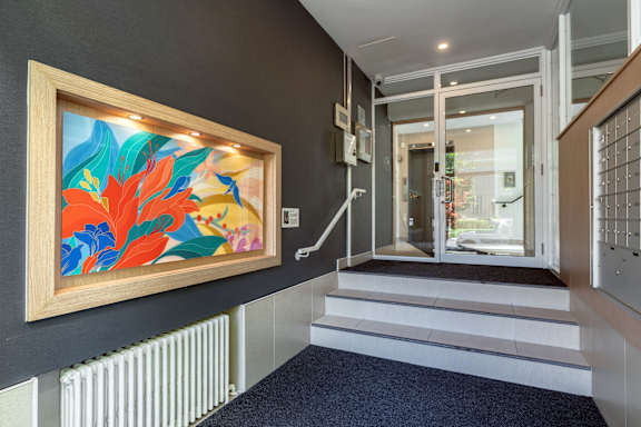 A hallway with a painting on the wall and a staircase.at 161 St. George, Toronto, CA M5R 2M3