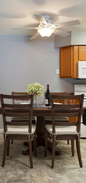 a dining room table and chairs in a kitchen  at Pebblebrook Flats, Bloomington, 55437
