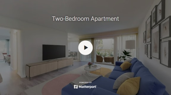 a two bedroom apartment with a blue couch and a tv