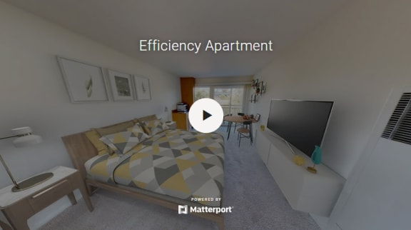 a bedroom with a bed and a tv  efficiency apartment