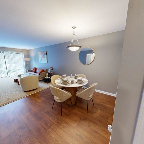 A dining room with a table set for four.