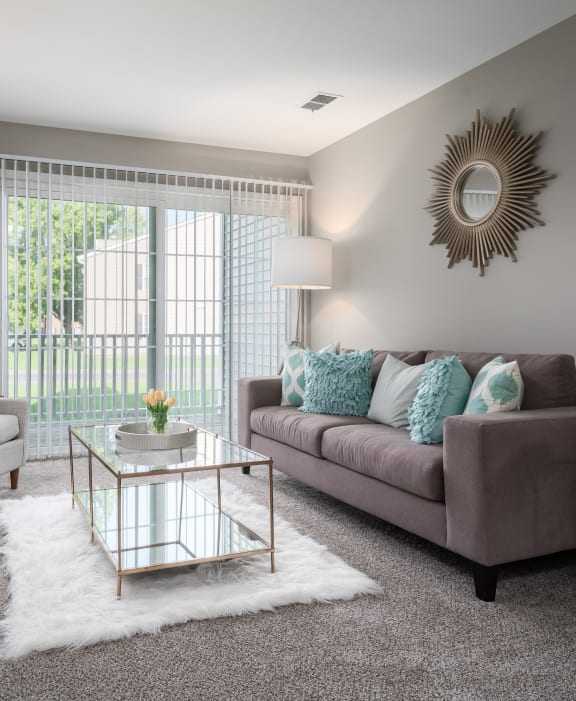 a living room with gray walls and a sliding glass door