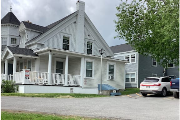 A house with a white porch and a sign that says 727.
