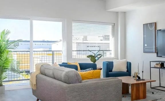 a living room with a couch and a chair and a television