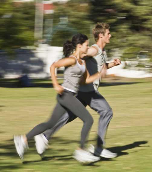 two people running in a park