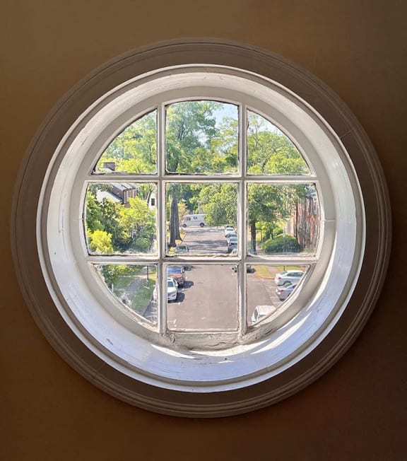 a round window with a view of a street