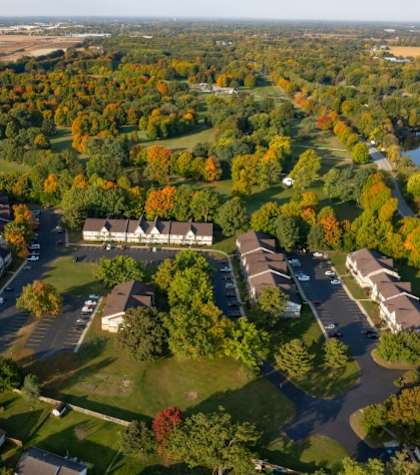 A bird's eye view of a residential area with houses and trees.