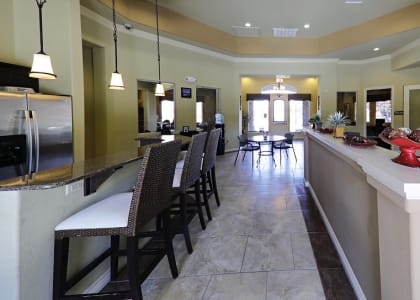 Beautiful clubhouse with a kitchen area and sitting area with TV and fireplace