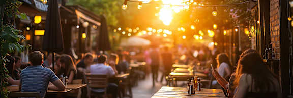A sunny day at a bustling outdoor restaurant with people dining and enjoying the warm weather.