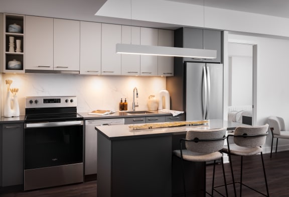 a kitchen with white cabinets and a table and chairs
