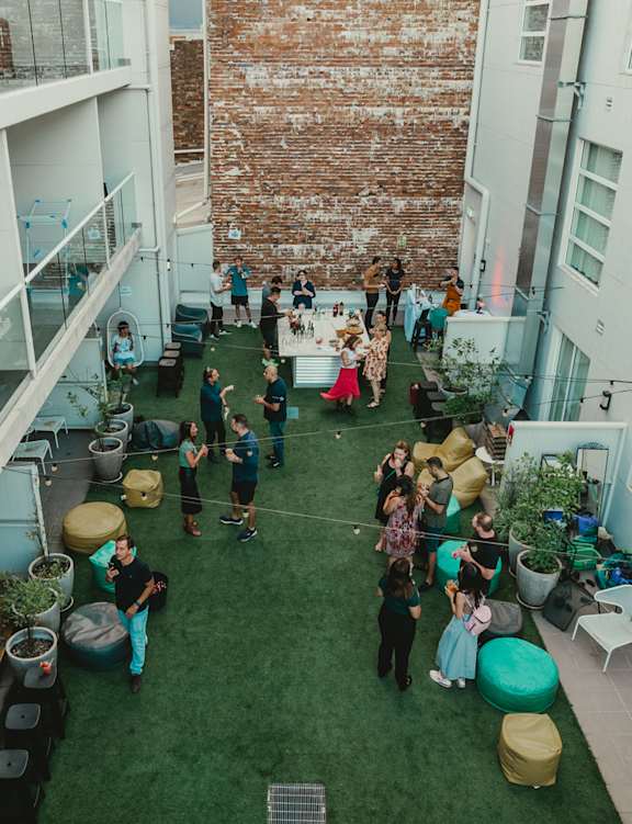 an aerial view of a group of people standing in an open courtyard
