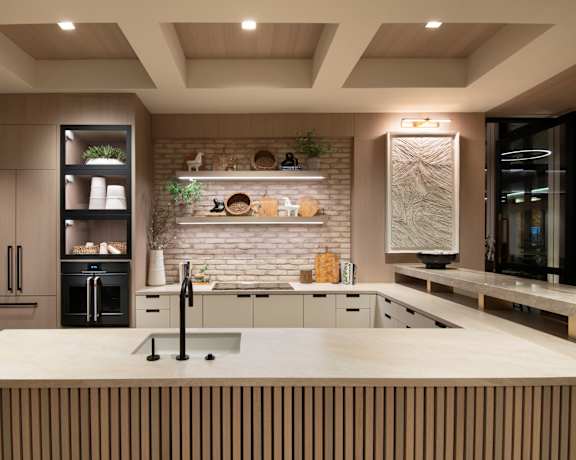 A modern kitchen with a large island and wooden accents.