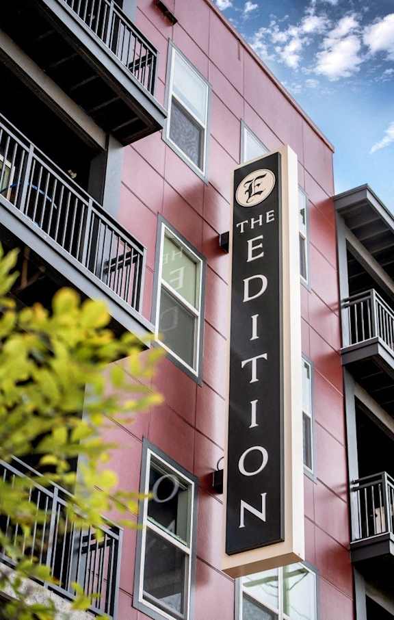 A red building with a sign that says "The Edition".
