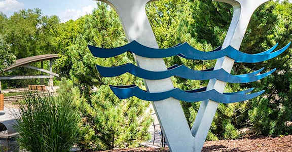a blue and white sculpture in a park
