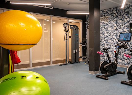 Fitness center with bikes and cable machine at Union 346, Massachusetts, 02143