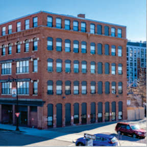 a brick building on the corner of a city street