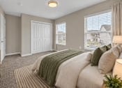 Thumbnail 14 of 40 - A bedroom with a large bed and a window with blinds.