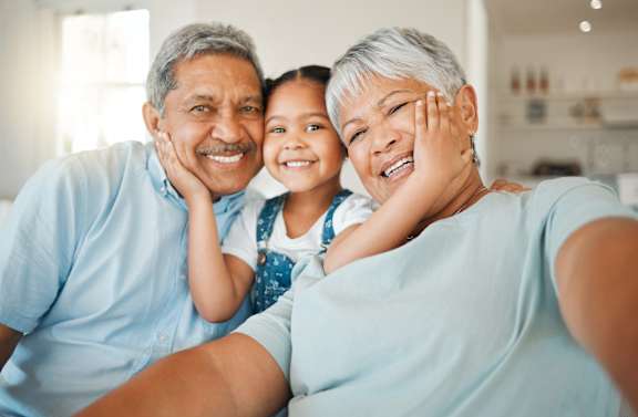 A family of three is taking a selfie together.