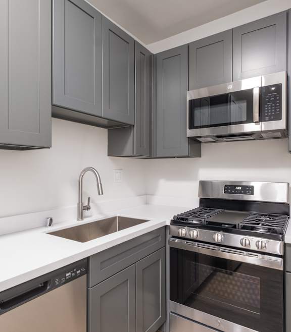 A modern kitchen with a stainless steel oven and microwave at Westmore Manor Apartments, Los Angeles, CA, 90020 at Westmore Manor Apartments, Los Angeles, 90020