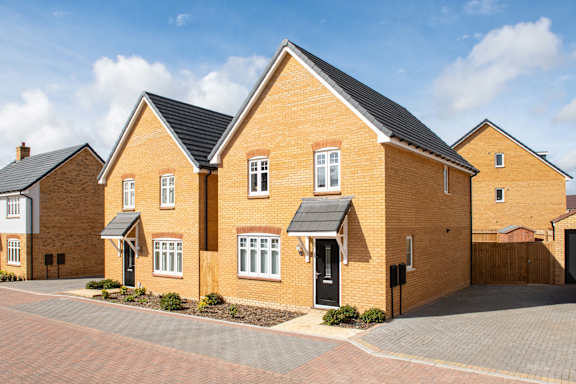A large brick house with a black door and windows.
