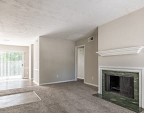 an empty living room with a fireplace and a doorway at Hidden Woods, Decatur, 30035