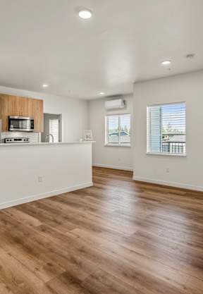 A modern living room with a grey sofa, a white armchair, and a wooden coffee table at Silverbrook Apartments Apartments, Ridgeland, 59901