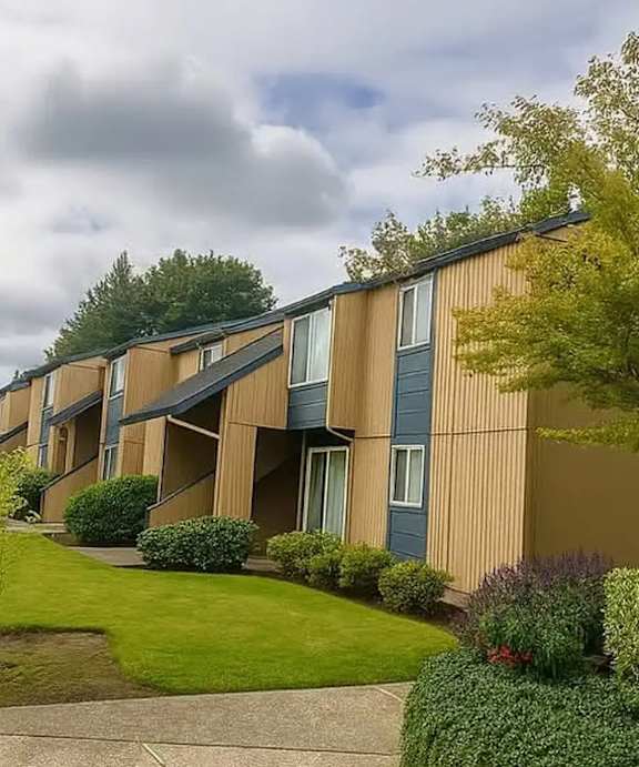 A sign for Briar Creek Apartments is surrounded by flowers.