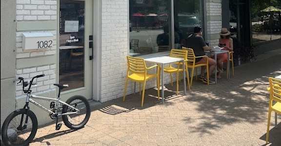 a bike parked outside of a cafe with tables and chairs at The Teale Navy Yard, North Charleston, South Carolina