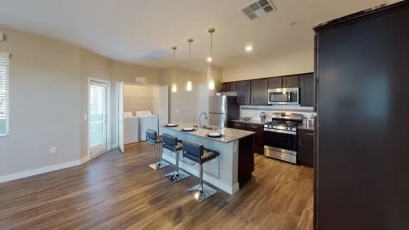 a kitchen and dining room with a table and chairs